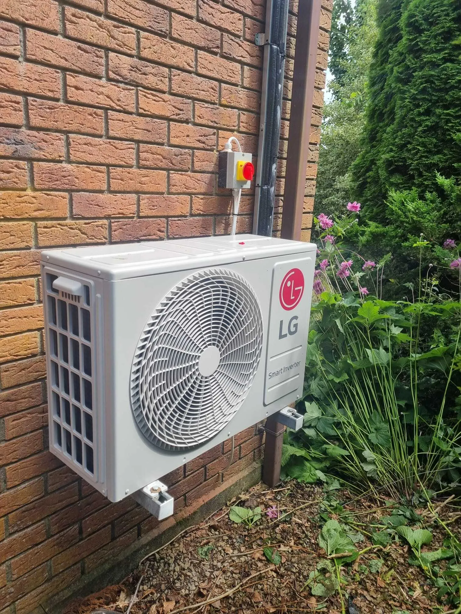 LG outdoor unit mounted on a brick wall