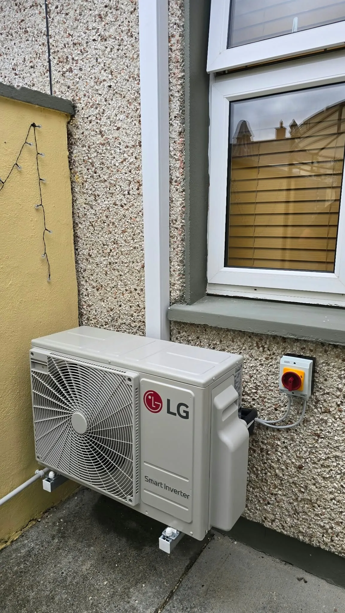 LG outdoor unit installed under a window