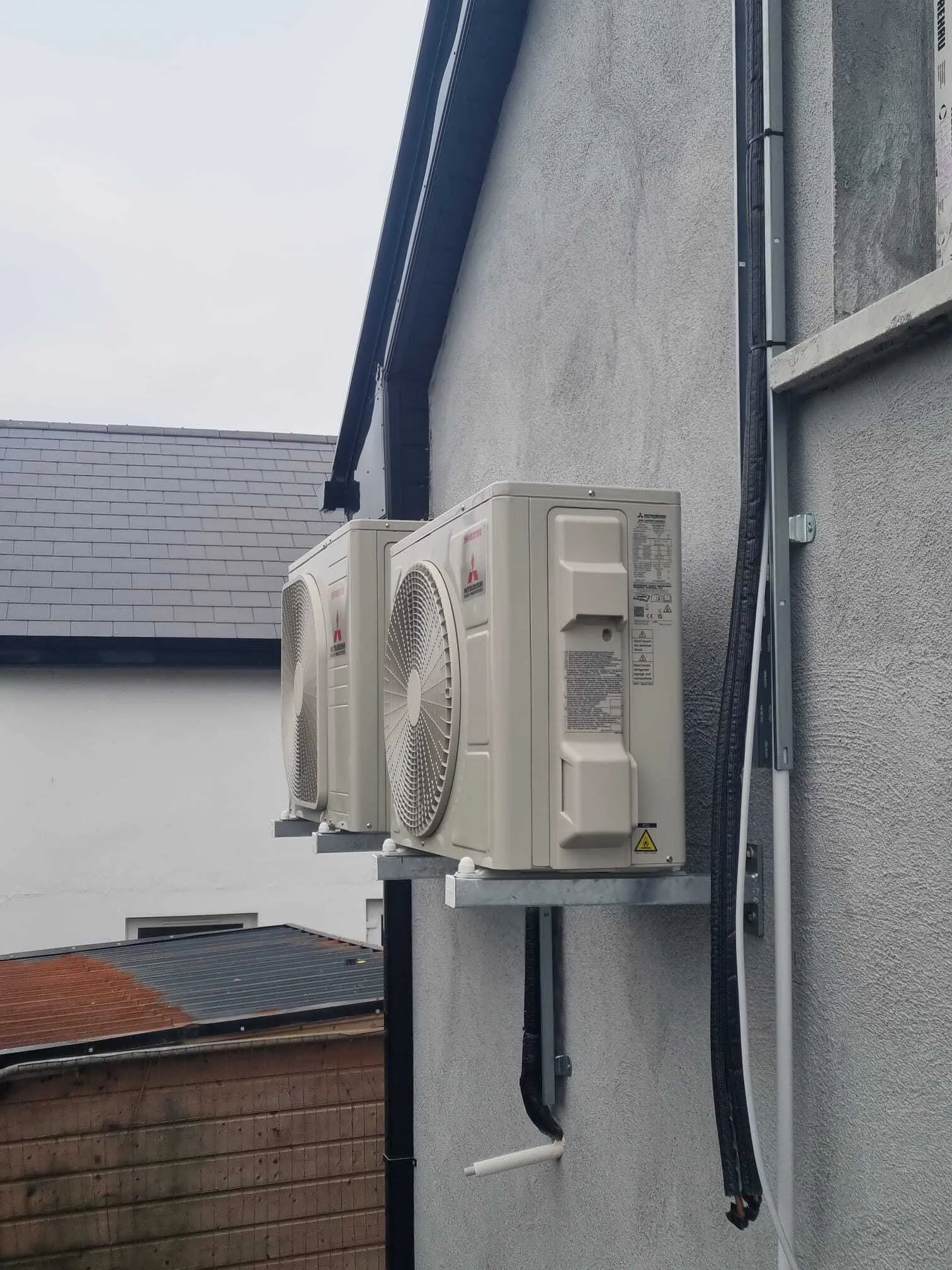 Mitsubishi outdoor units on wall brackets