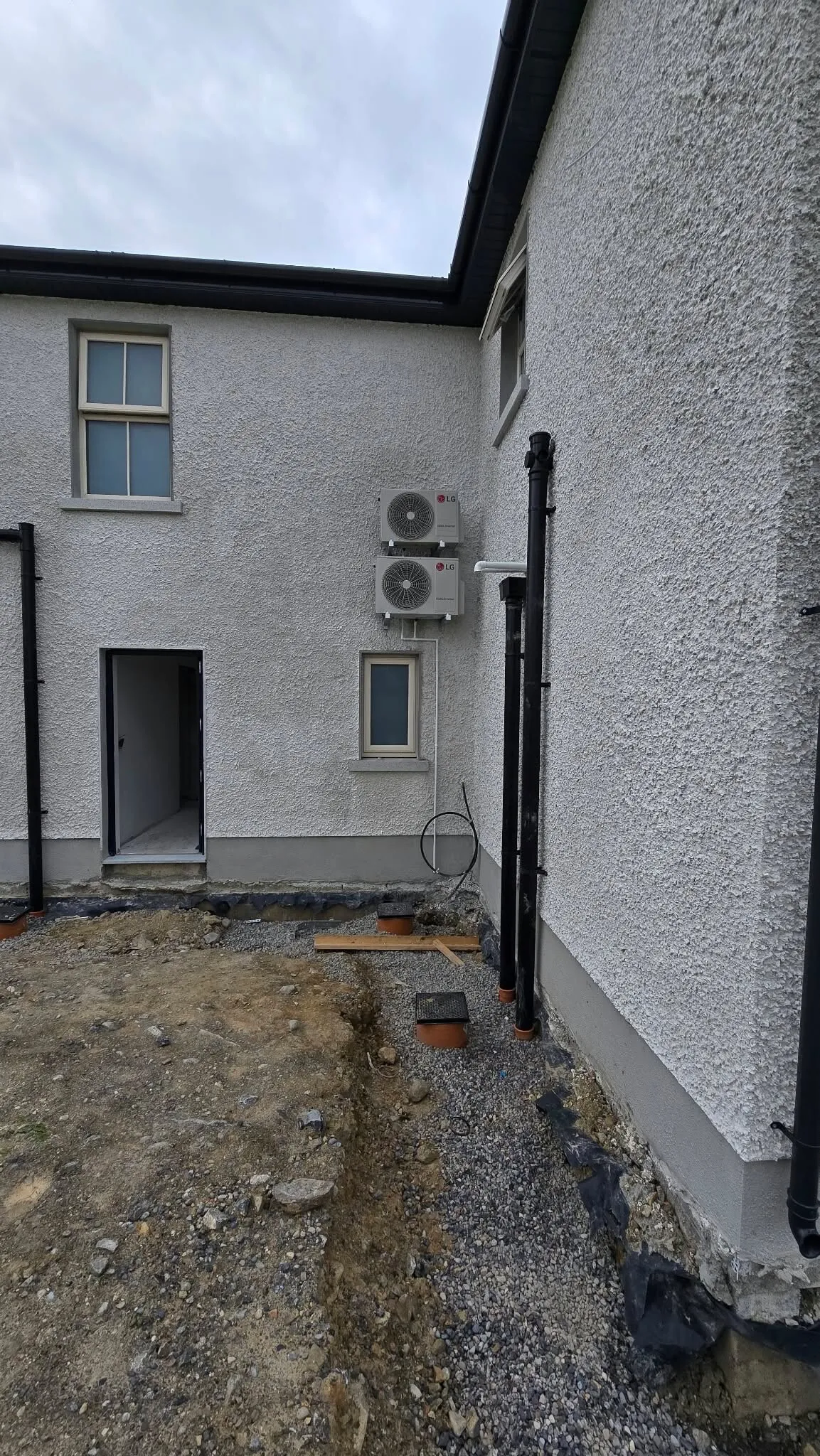 Outdoor units mounted on the side wall of a house