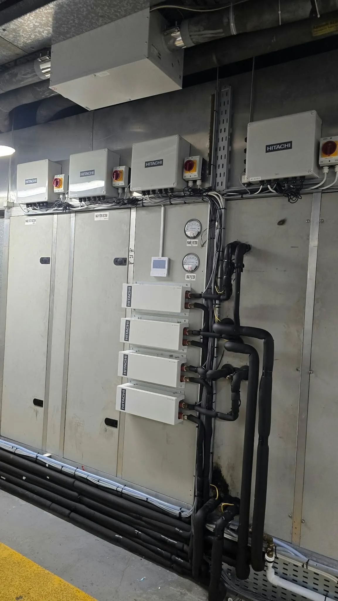 VRF branch boxes and insulated pipework in a plant area