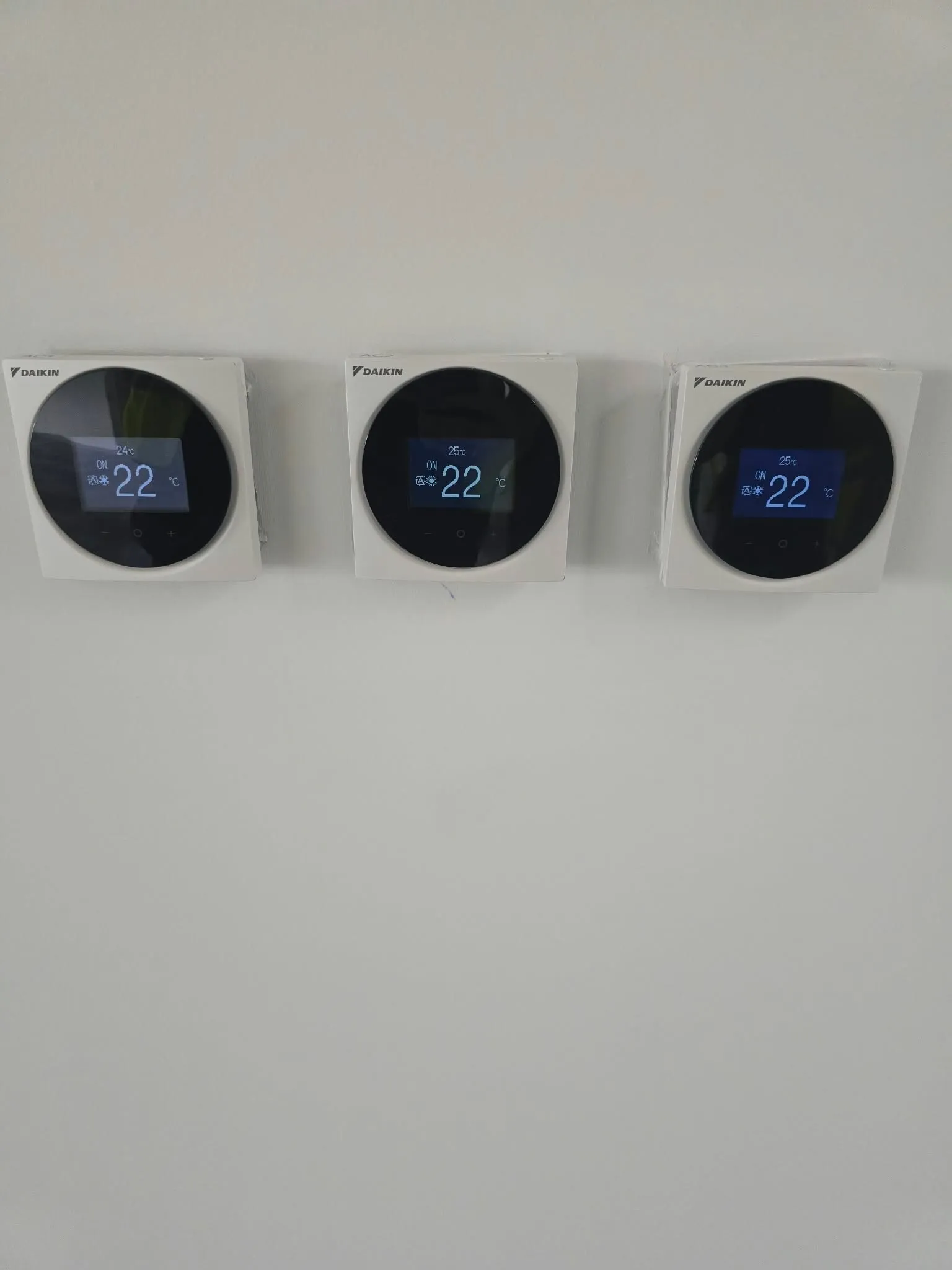 Three wall-mounted air conditioning controllers
